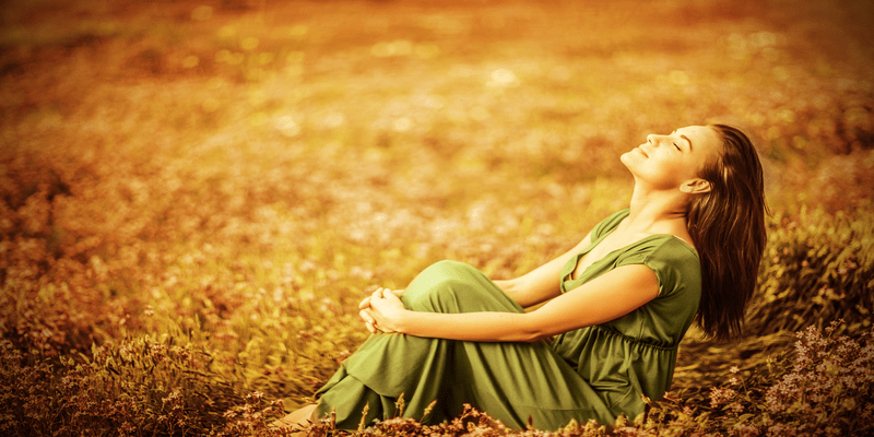 woman enjoying the sun in a field