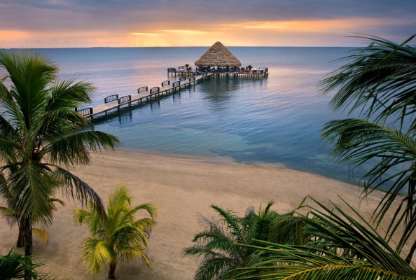caribbean-pier-with-thatch-roof-at-sunrise