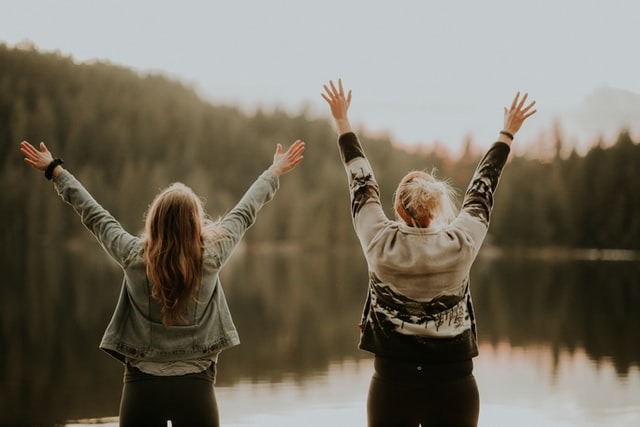 two women celebrating the feeling of freedom and accomplishment