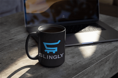 slingly logo on a black coffee mug next to a laptop