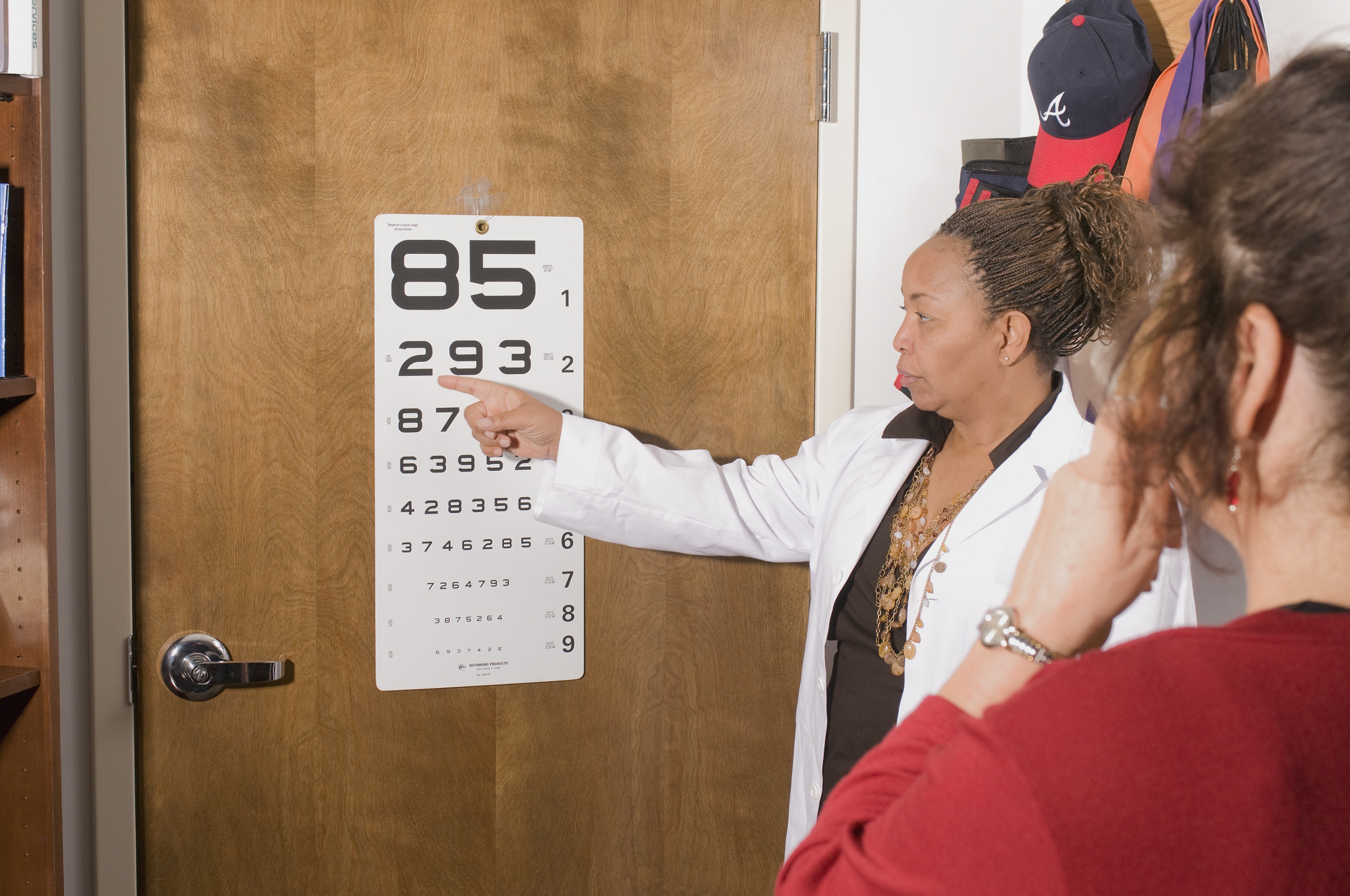 Neuro-Optometrist pointing to eye chart