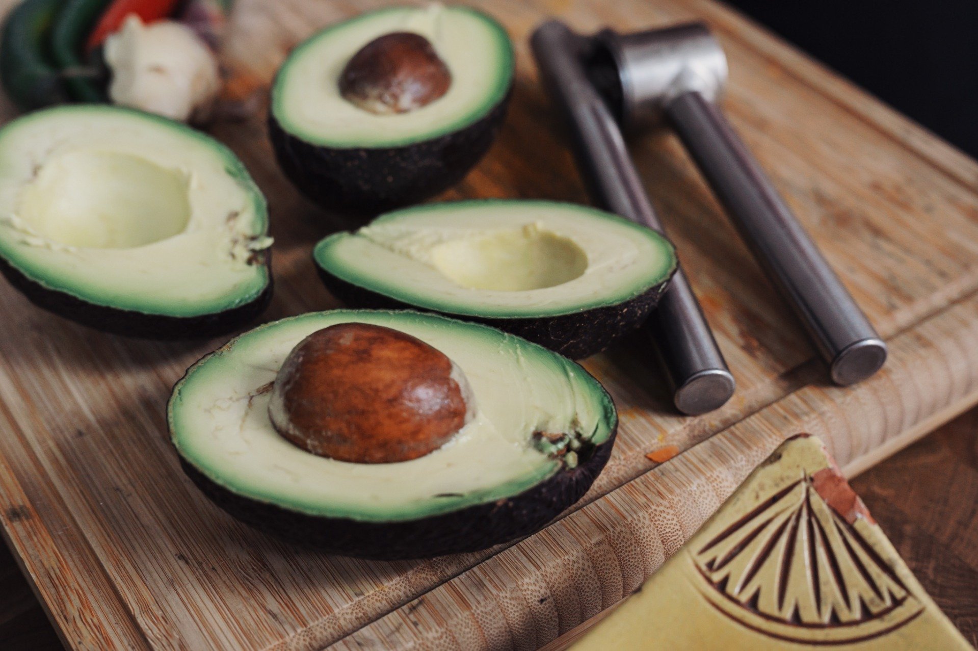 Avocado halves on a board ready to be served as a Superfood due to their good fatty acids.