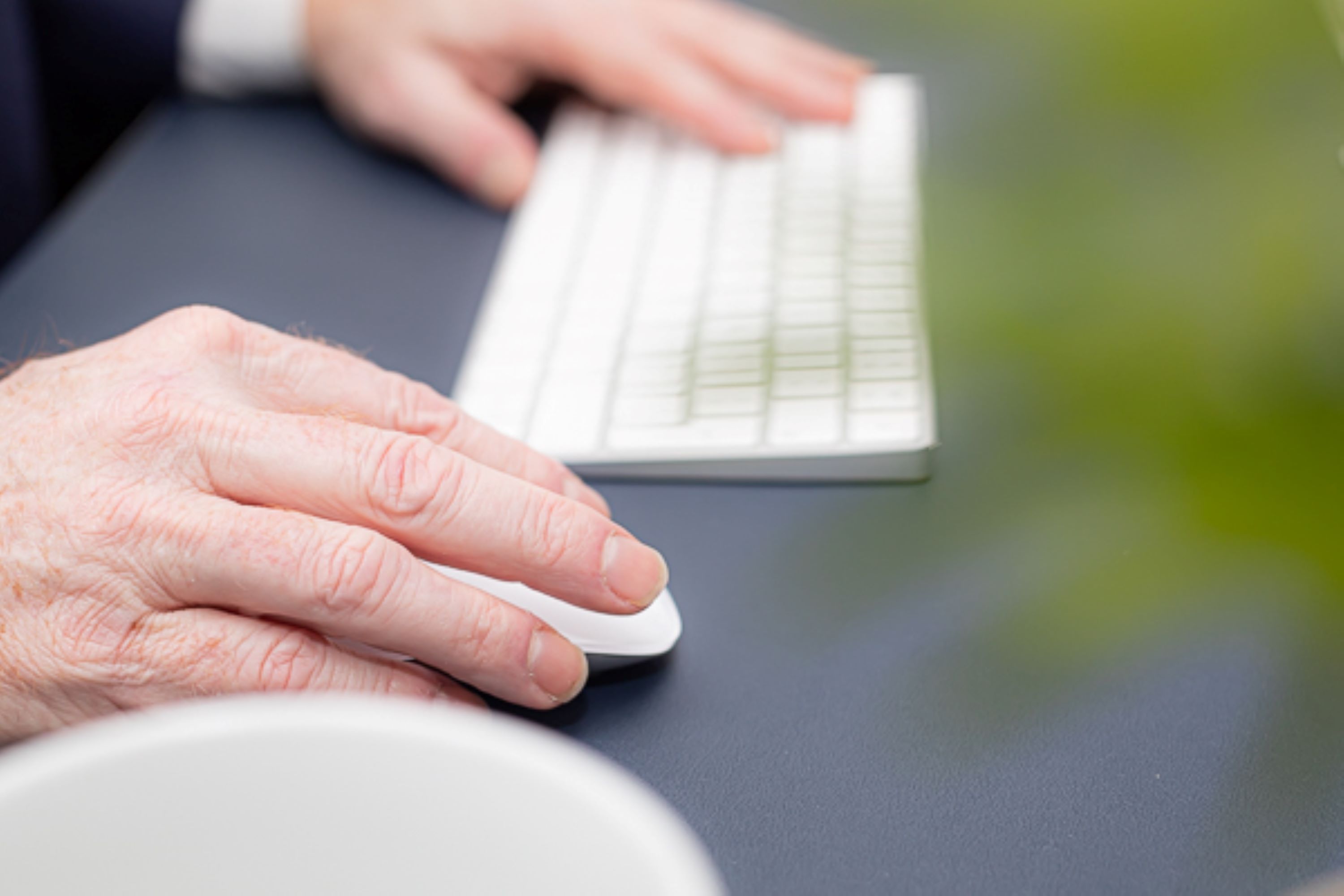 businessman-office-desk-computer-keypad-hands