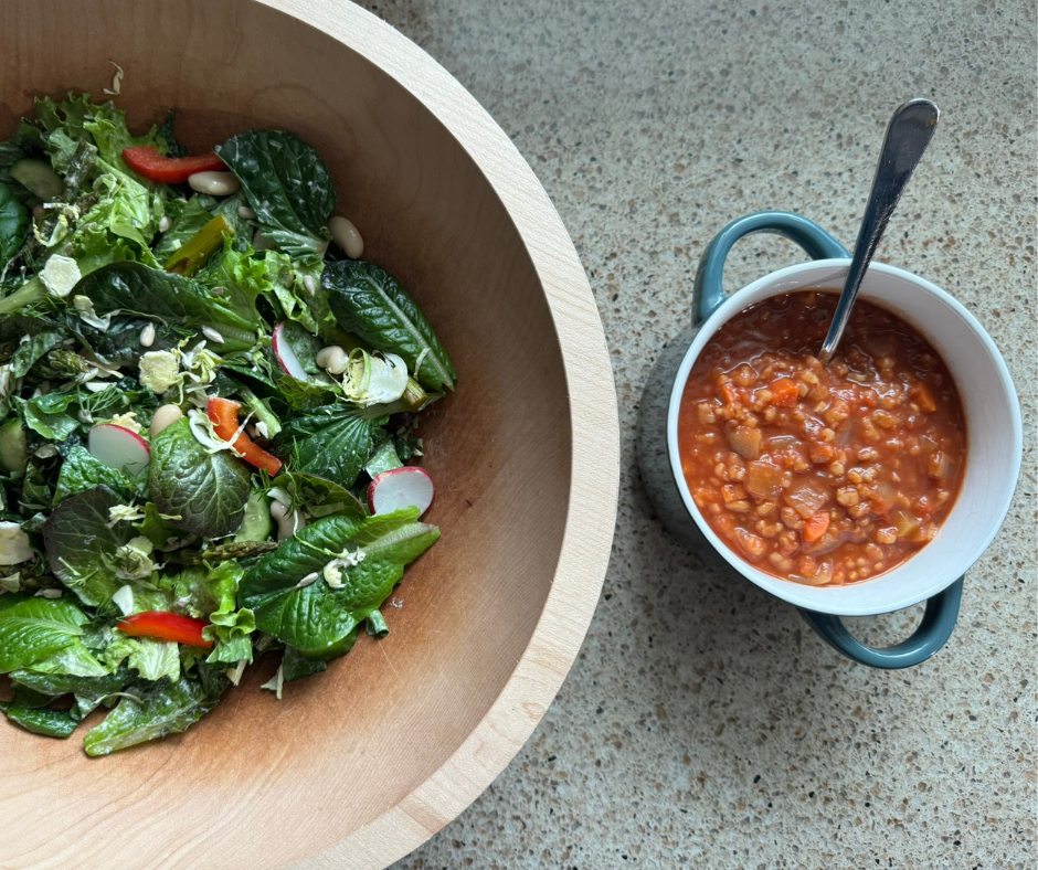 Lemon-Dill Asparagus and White Bean Salad of the Week served with creamy tomato rice soup on a kitchen counter