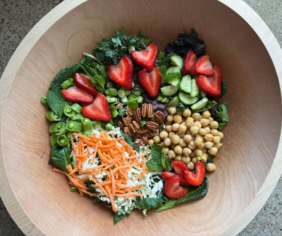 Simple Prep Strawberry Chickpea Garden Bowl with fresh strawberries, chickpeas, crisp vegetables, and pecans.