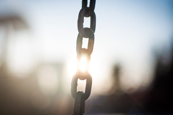 Image of breaking a chain with sunshine in the background. Other people's bad decisions no longer steal my time like they did in corporate life.
