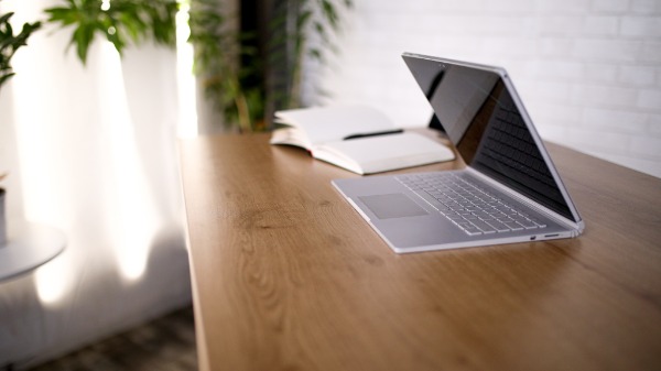 laptop on a clean desk as you get your to-do list ready for launching a business from home using Cyndi Zaweski's tips