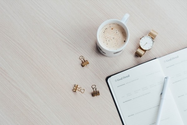 coffee and calendar to keep organized and track your income goals