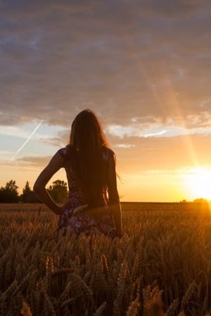feel a sense of freedom like a woman watching the sunset in an empty meadow