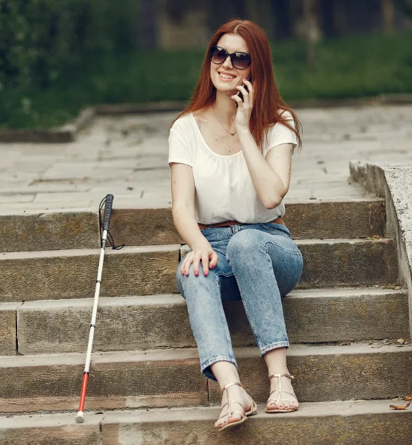 young blind person in city on steps