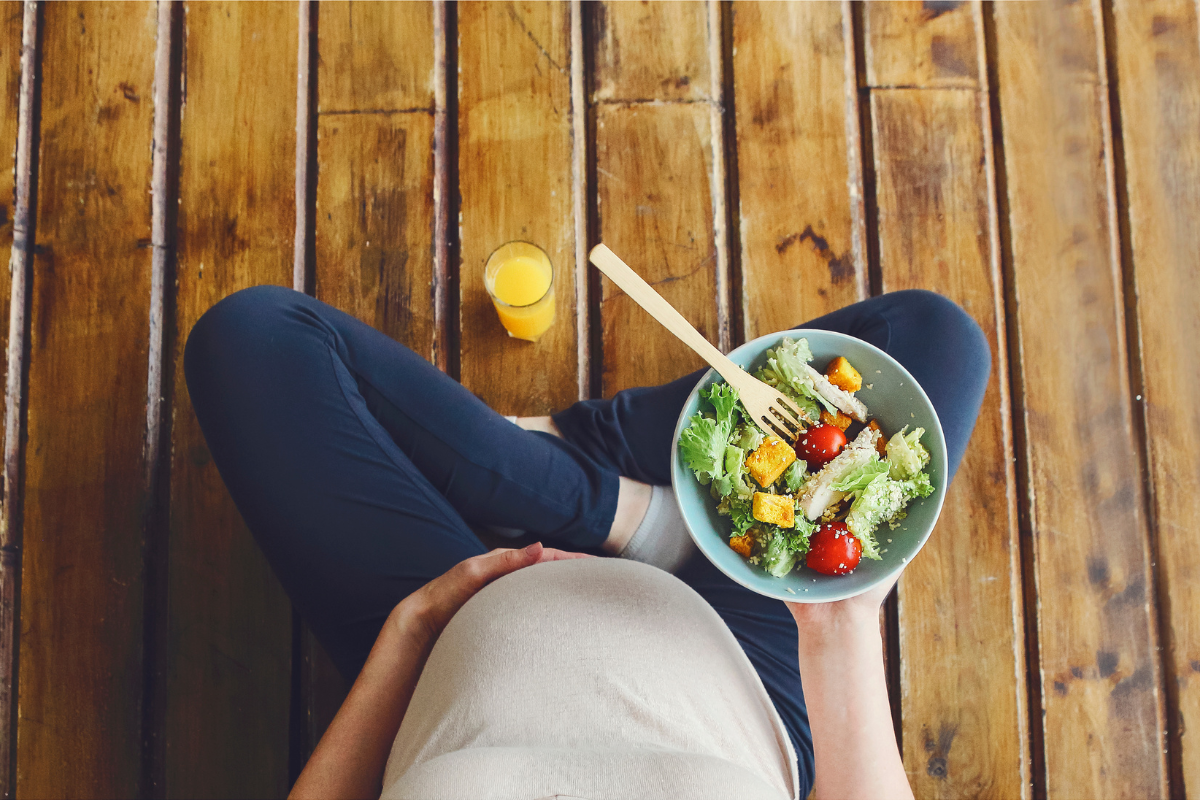 A pregnant woman eating delicious food for IVF nutrition
