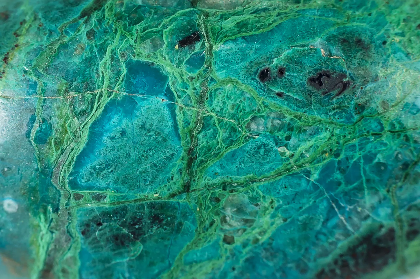 Close-up of the intricate structure of a Chrysocolla gemstone, known for awakening hidden talents, soothing stress, and enhancing self-expression and love