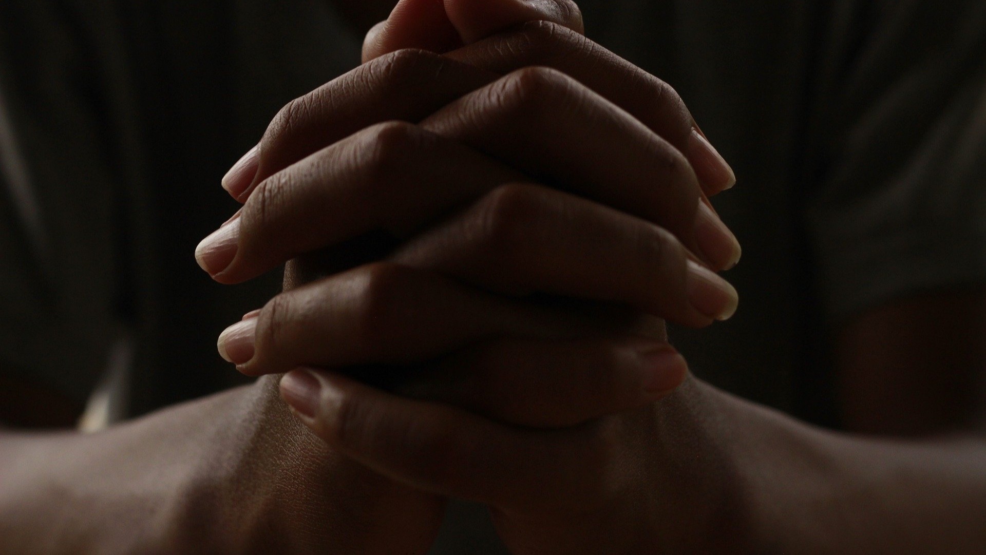Two hands clasped together in prayer