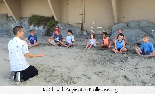 tai chi instructor Angie Sierra sitting down on the beach sand with children showing them how to meditate